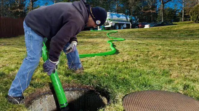 Service technician performing residential septic pumping and drainage maintenance in Ogden, UT
